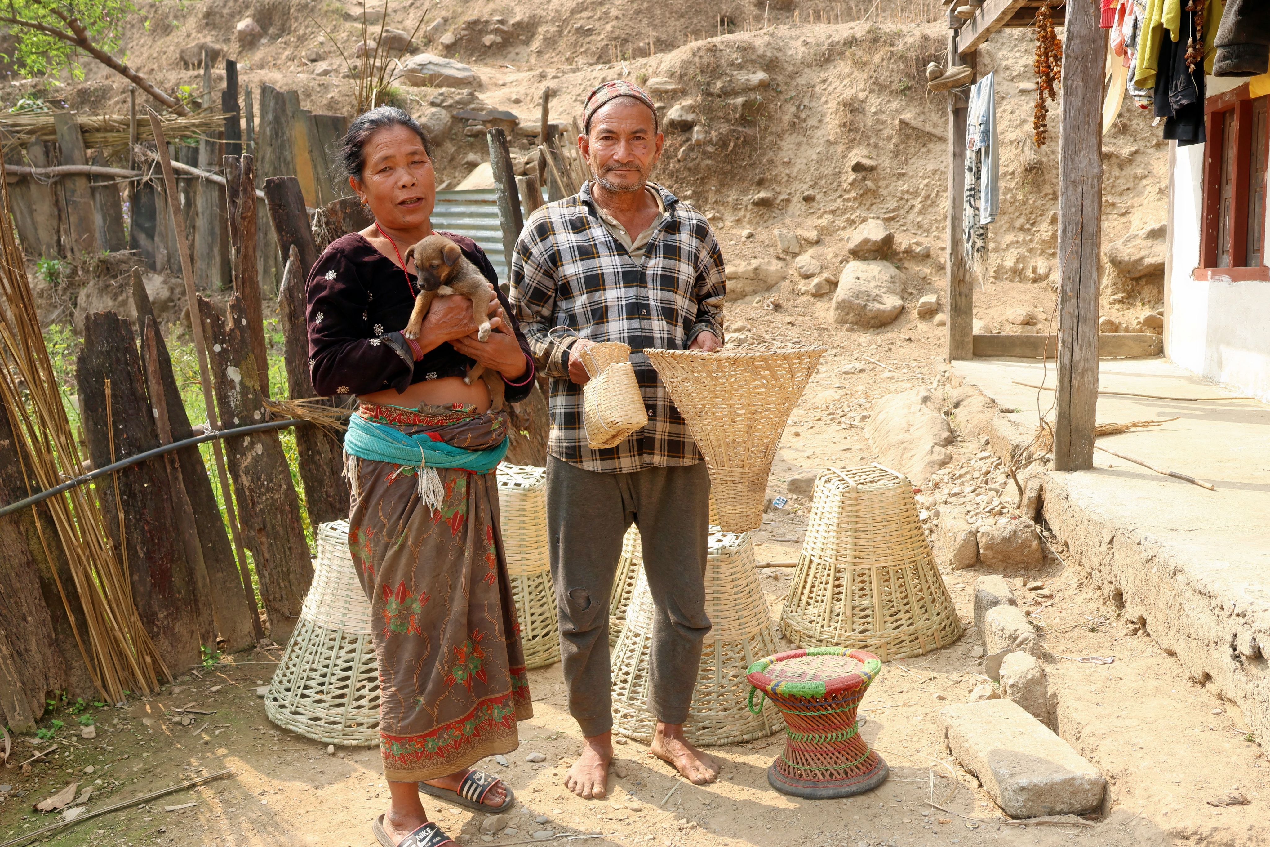 Hira Maya Syangtan and her husband Hasta Bahadur Chepang show their locally produced items to be sold at a community market